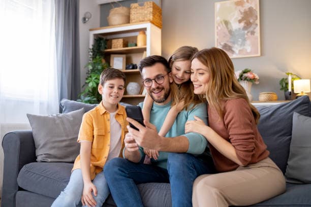 Family using a phone together at home